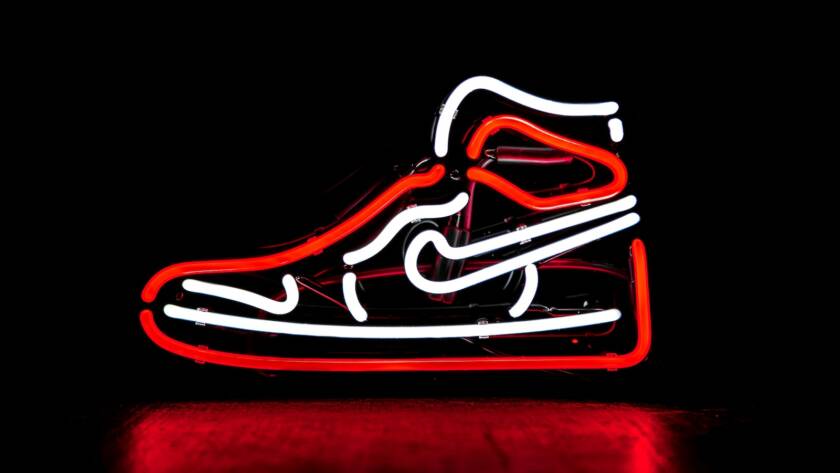 red and white Nike basketball shoe neon signage