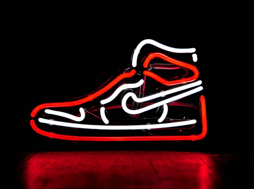 red and white Nike basketball shoe neon signage